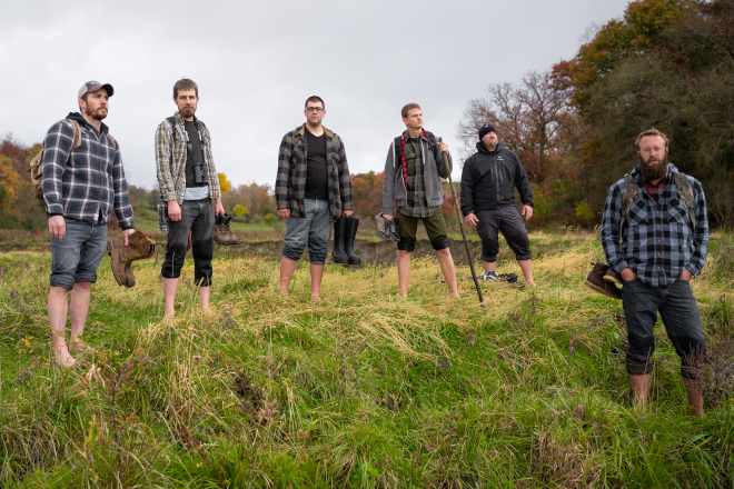 Group of men posing for camera