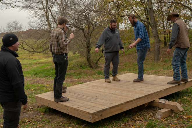 Men teambuilding on balance board