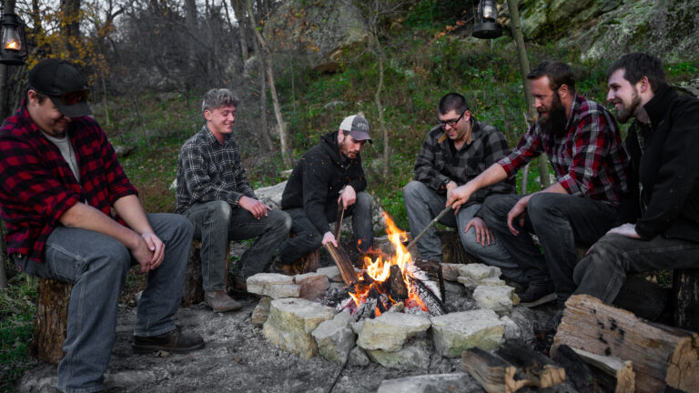 Men around campfire.