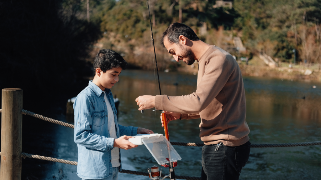 Father teaching son to fish.