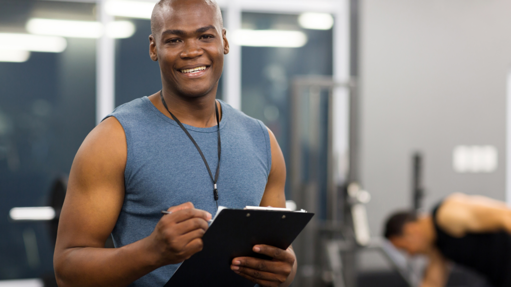 Male physical fitness instructor reading off a clip board.